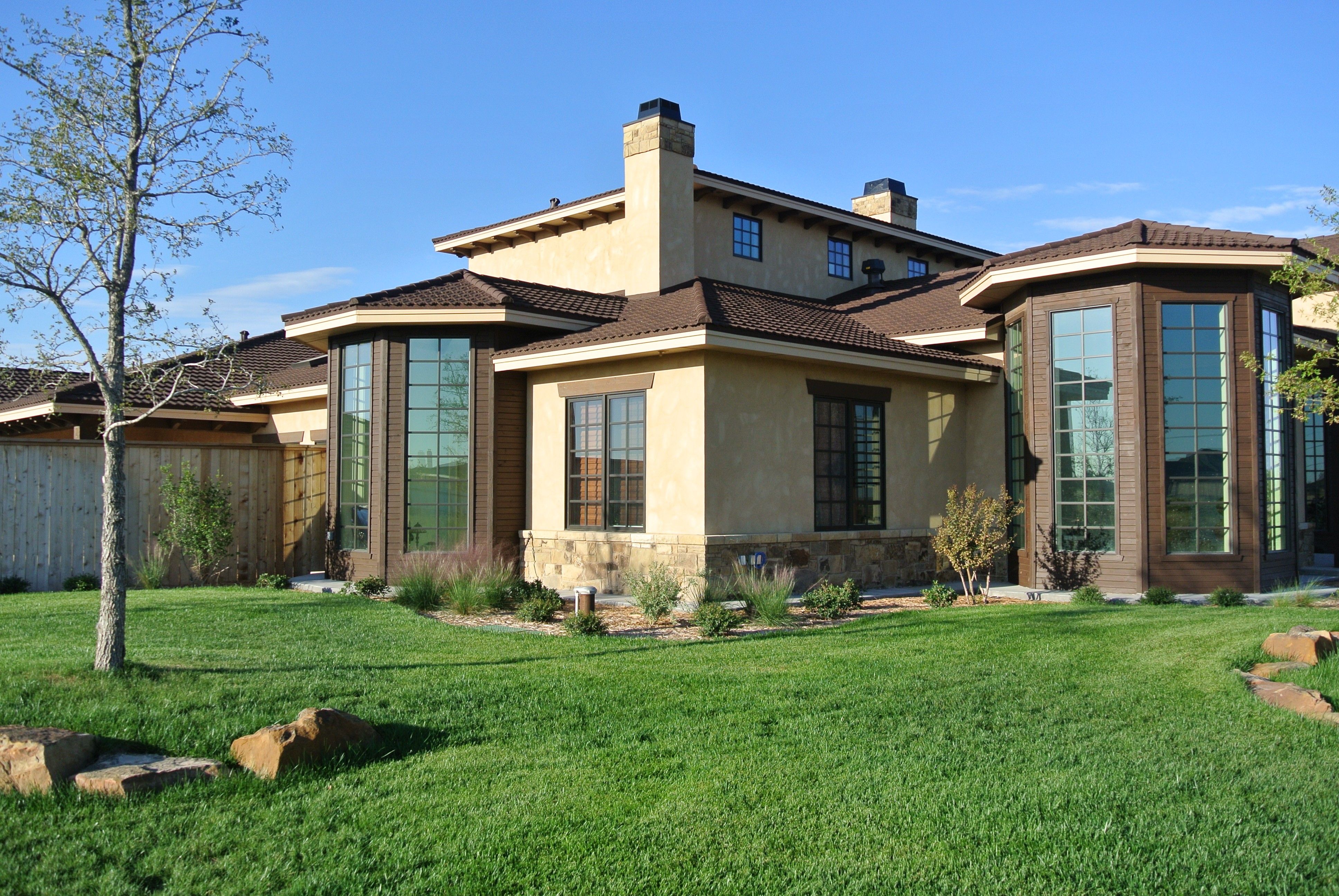 Gerard Tile Barclay dark brown stone-coated steel on stucco home