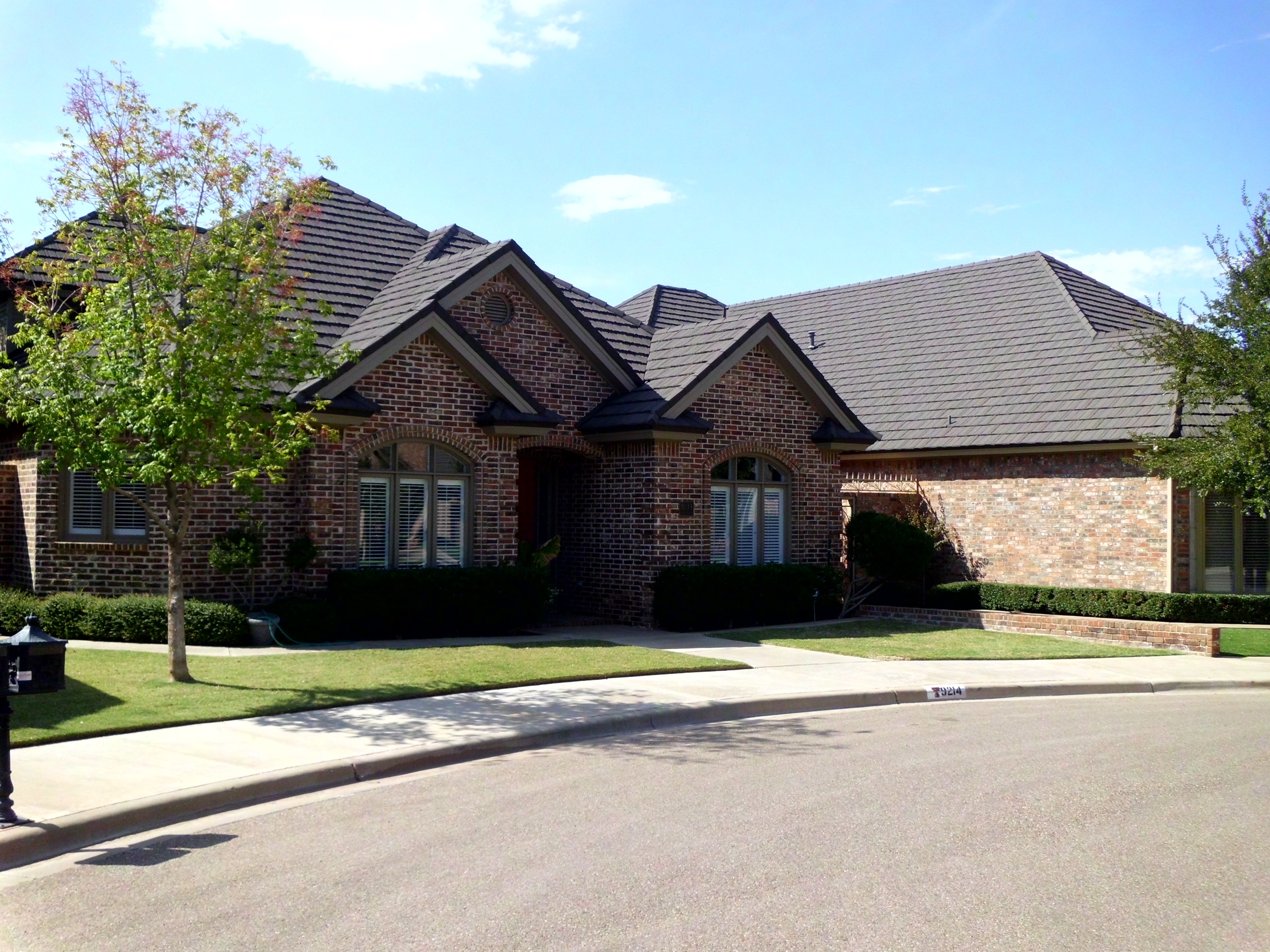 Roof replacement on brick home with arched entryway, Central Texas
